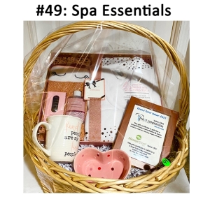 This basket includes a mug, heart-shaped dish, gift cards, and a spa essentials kit.