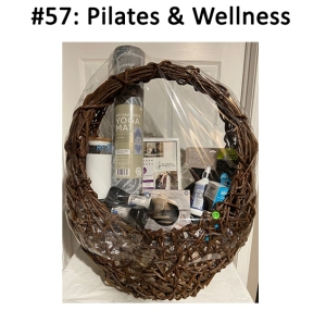 This basket includes a yoga mat, dumbbells, wet brush, gift certificate, medicine ball, hair ties, socks, bag, and cleaner spray.