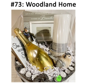 This basket includes a snowman ornament, plaques, gift card, candle & candle holder, ceramic bird, ornament, wine, and a frame.