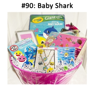 This basket includes a headband, crayons, gift card, and various Baby Shark themed items.