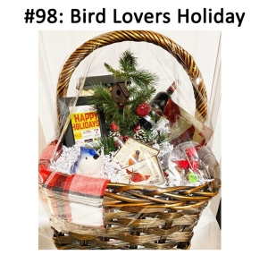 This basket includes wine, gift card, winter pine & birds plant artificial arrangement, bronze & yellow bird mailbox, snowglobe, plaques, glass platter, and a blue jay votive holder & candle.